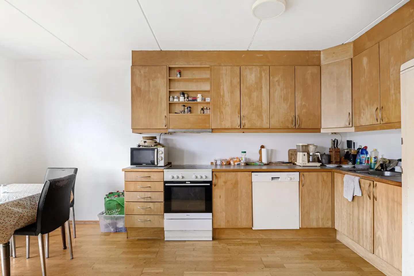 Kjøkkenet har innredning med glatte fronter og laminatbenkeplate.
